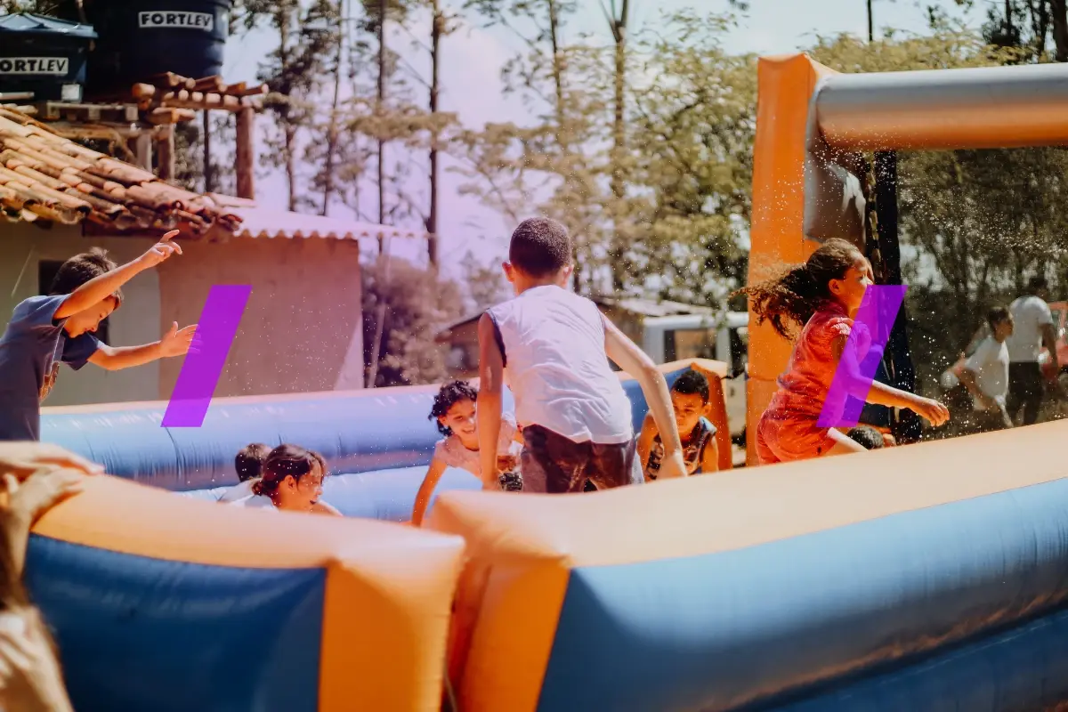 Comer image for the article: How Much Does It Cost to Start a Bounce House Rental Business: A Detailed Overview. The image shows kids jumping in an inflatable bouncy castle.