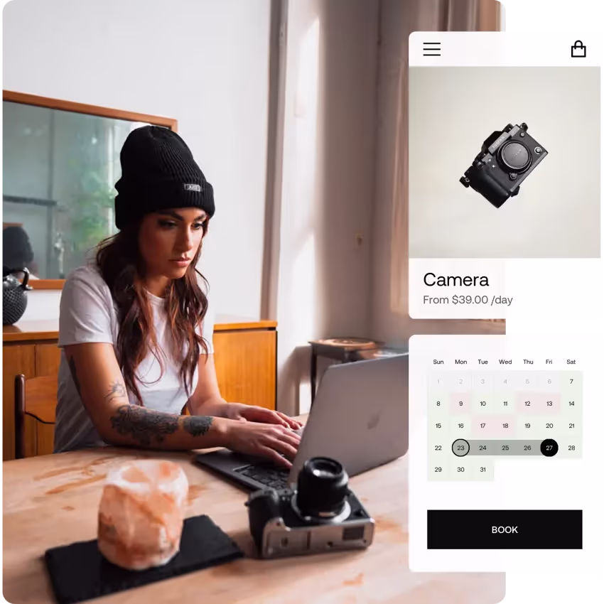 Woman using laptop on a table next to a camera with a mockup of camera rental page featuring a booking calendar for a camera